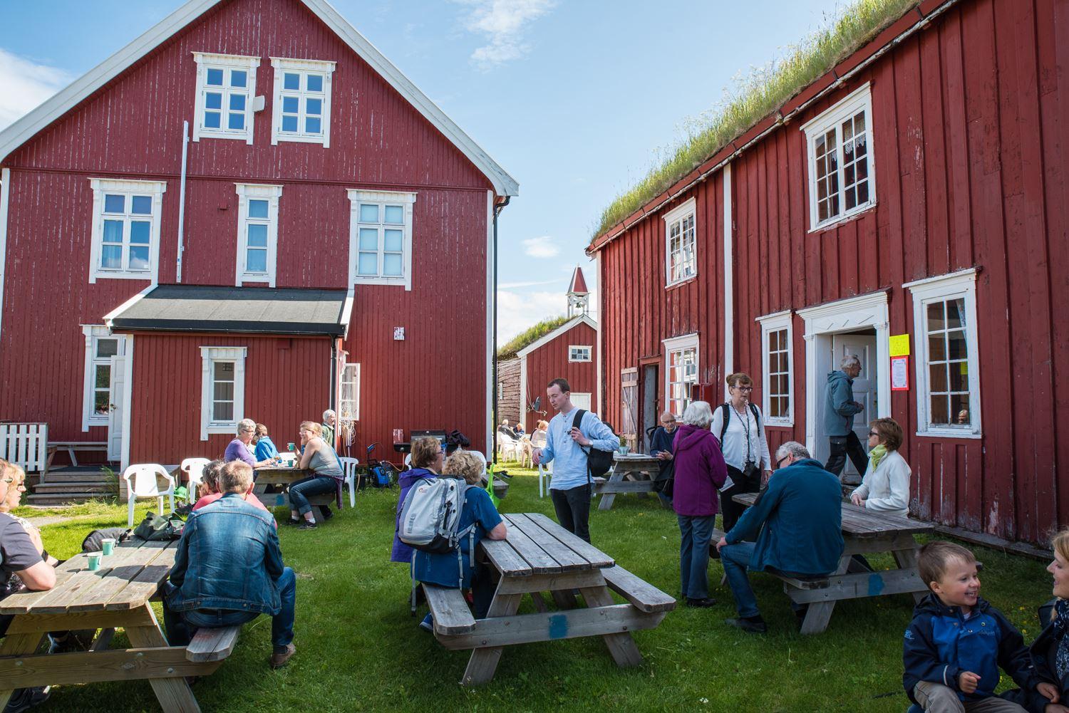 Gathering of people among traditional buildings.