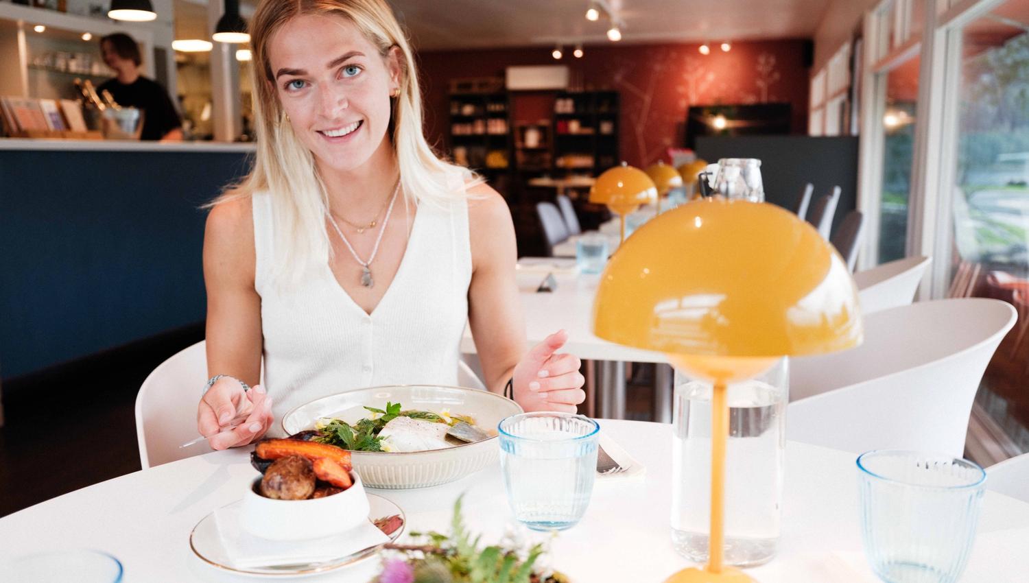 A guest about to enjoy a seasonal dinner at Gløyp Spiseri in Kinsarvik.