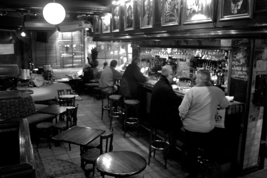 Black and white photo of interior with customers.