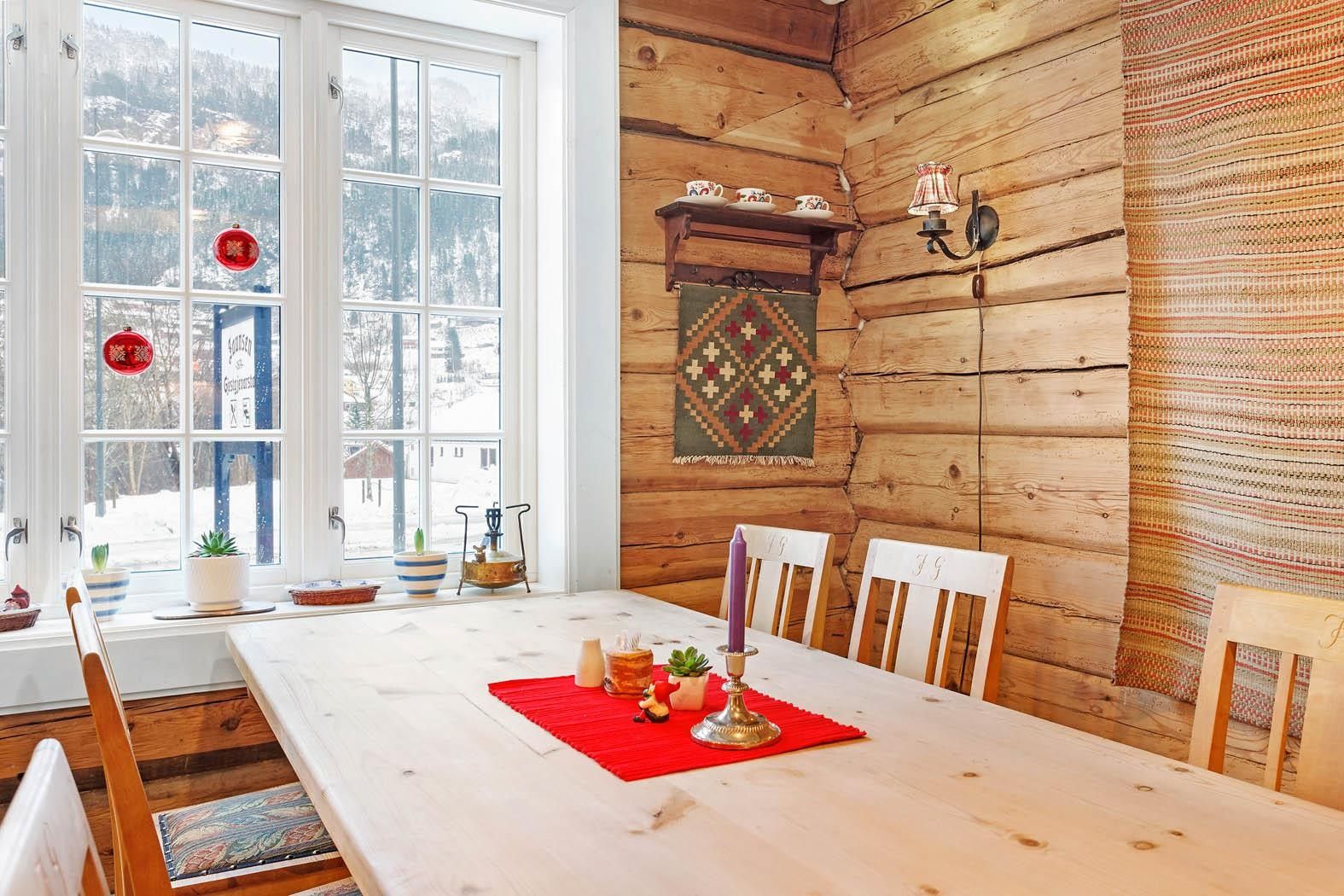 Bright, cozy room with log walls and mountain views at Jaunsen Guesthouse in Hardanger.