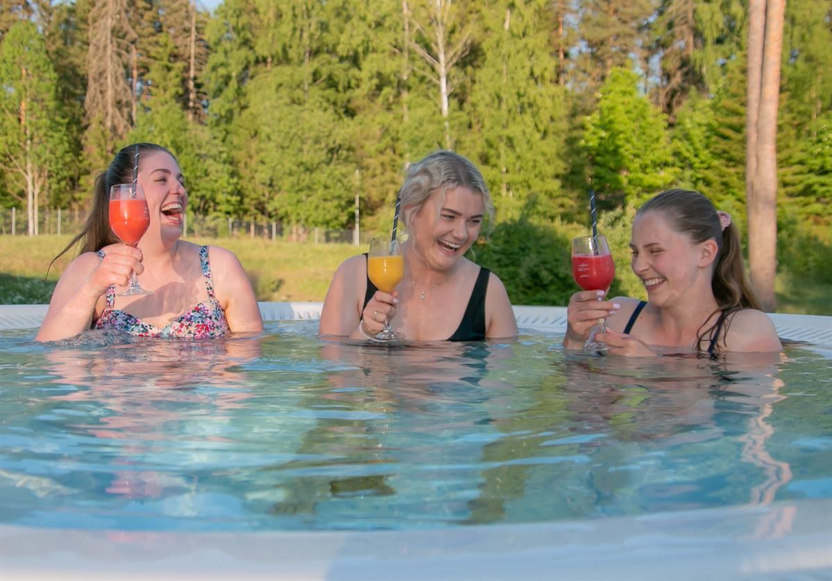 Tree girls with moctails in a outdoor pool