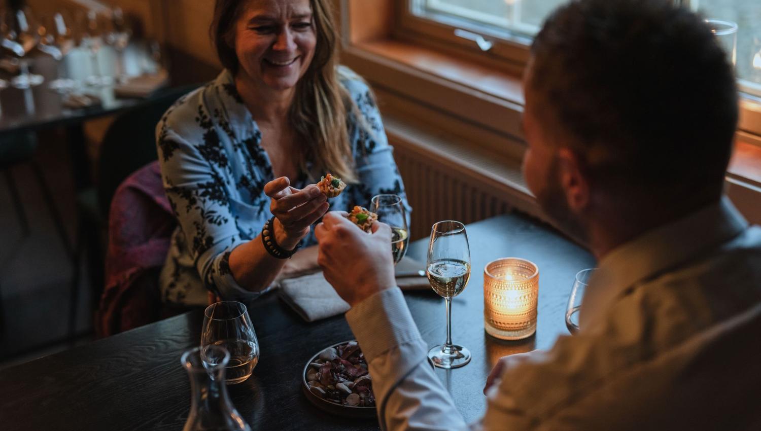 Two persons eating together at a table