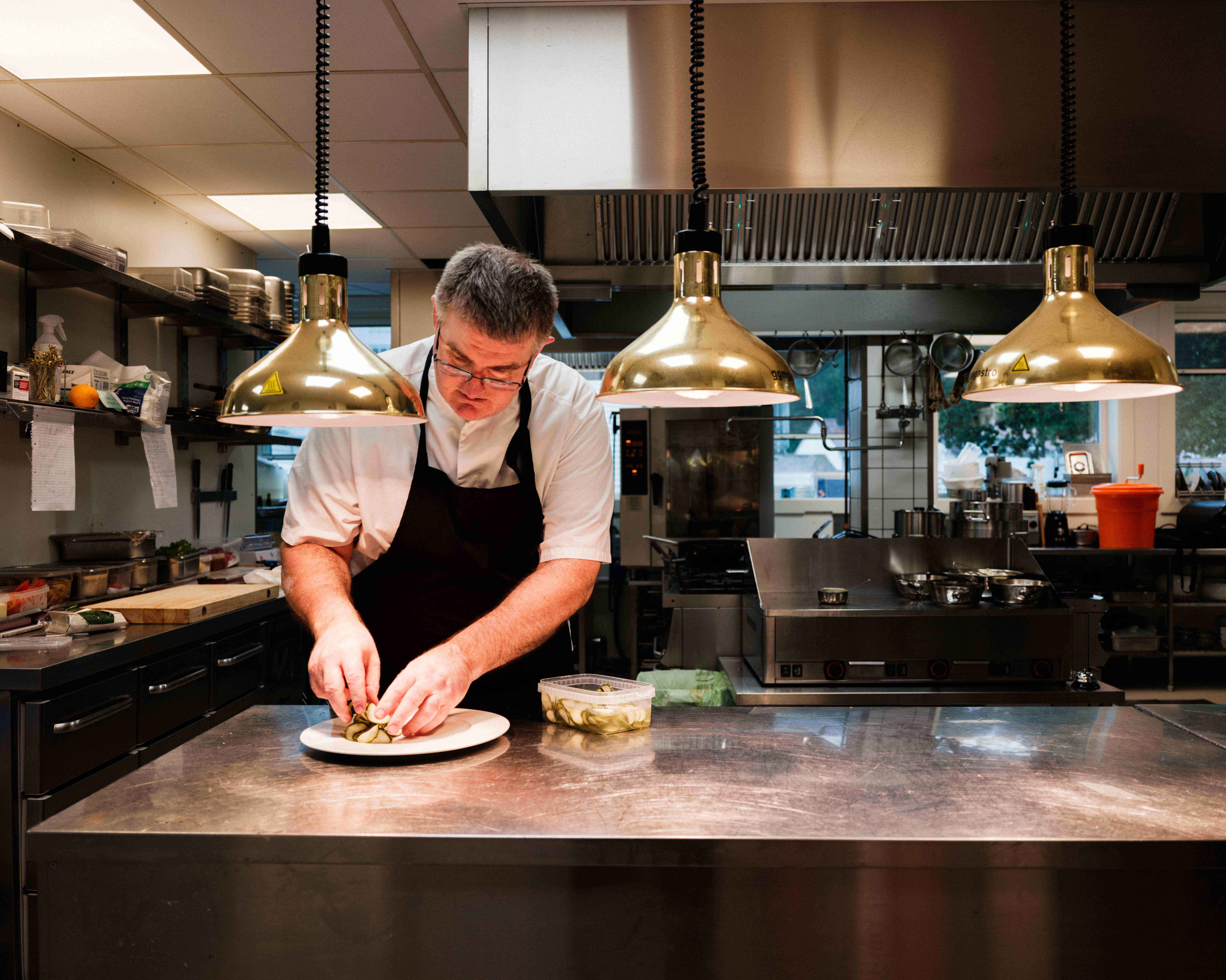 The chef at Kinsarvik Fjordhotel adding the final touch before serving.