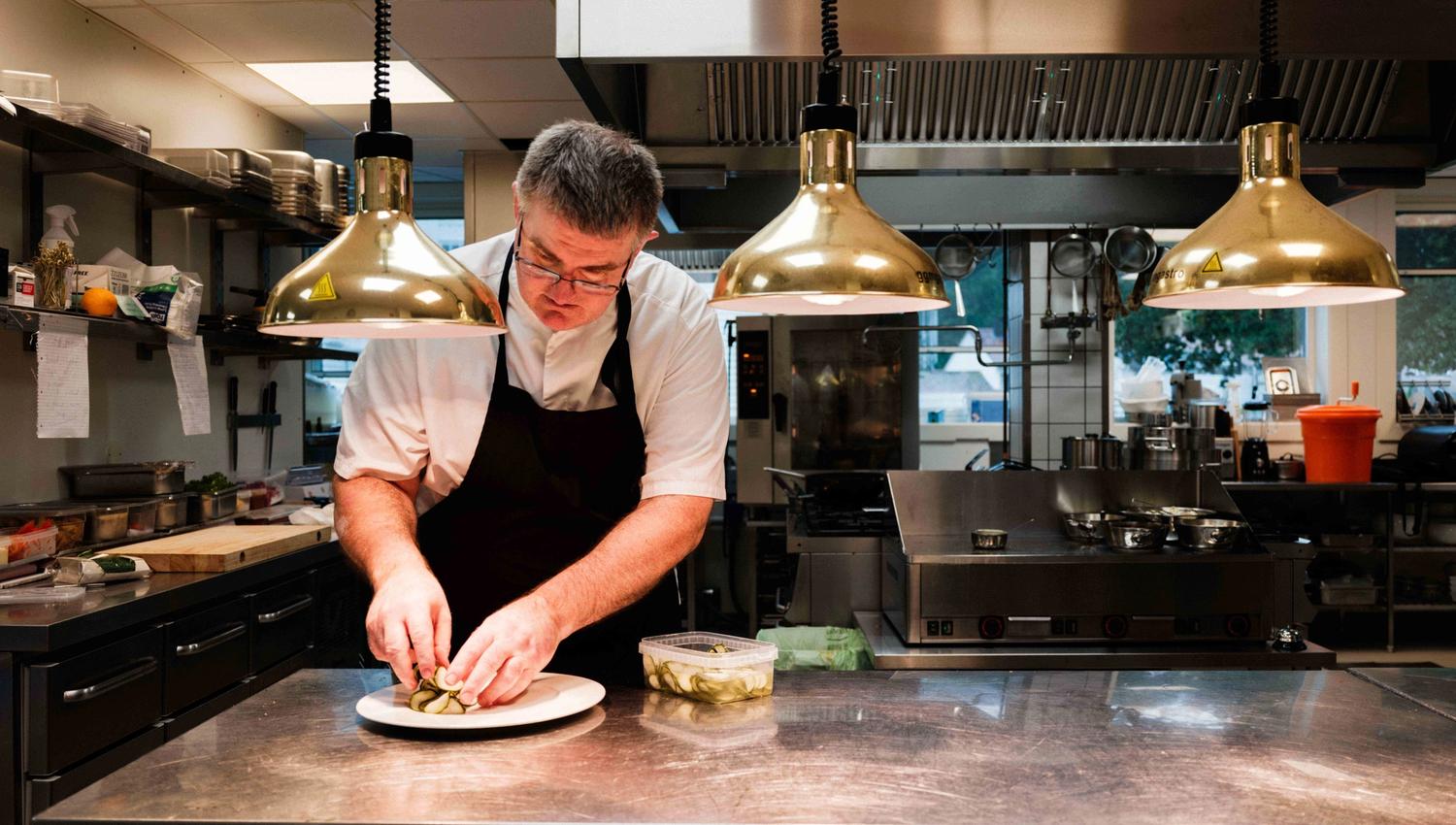 The chef at Kinsarvik Fjordhotel adding the final touch before serving.