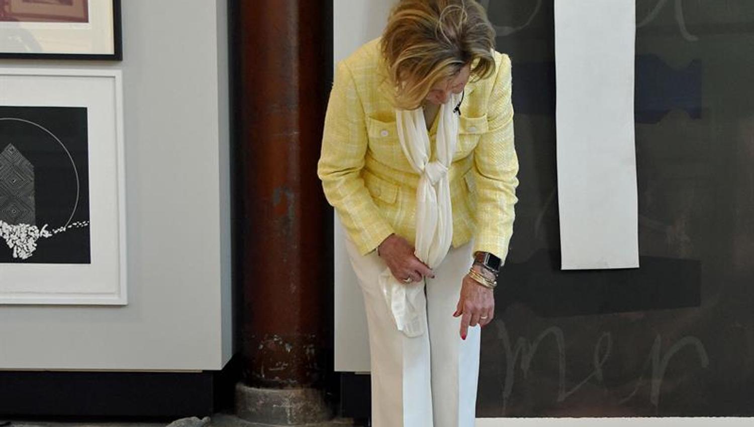 The Queen looking at art on the floor