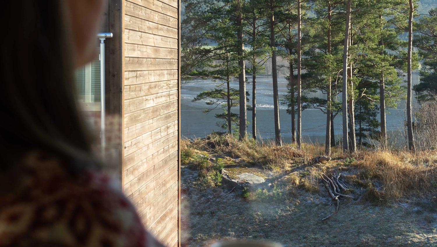 Fjord and forest view from a guest room at Husnes Sentrum Hotel.