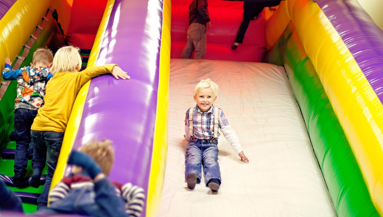 Lykkeland a play centre in Steinkjer - girl going down the slide