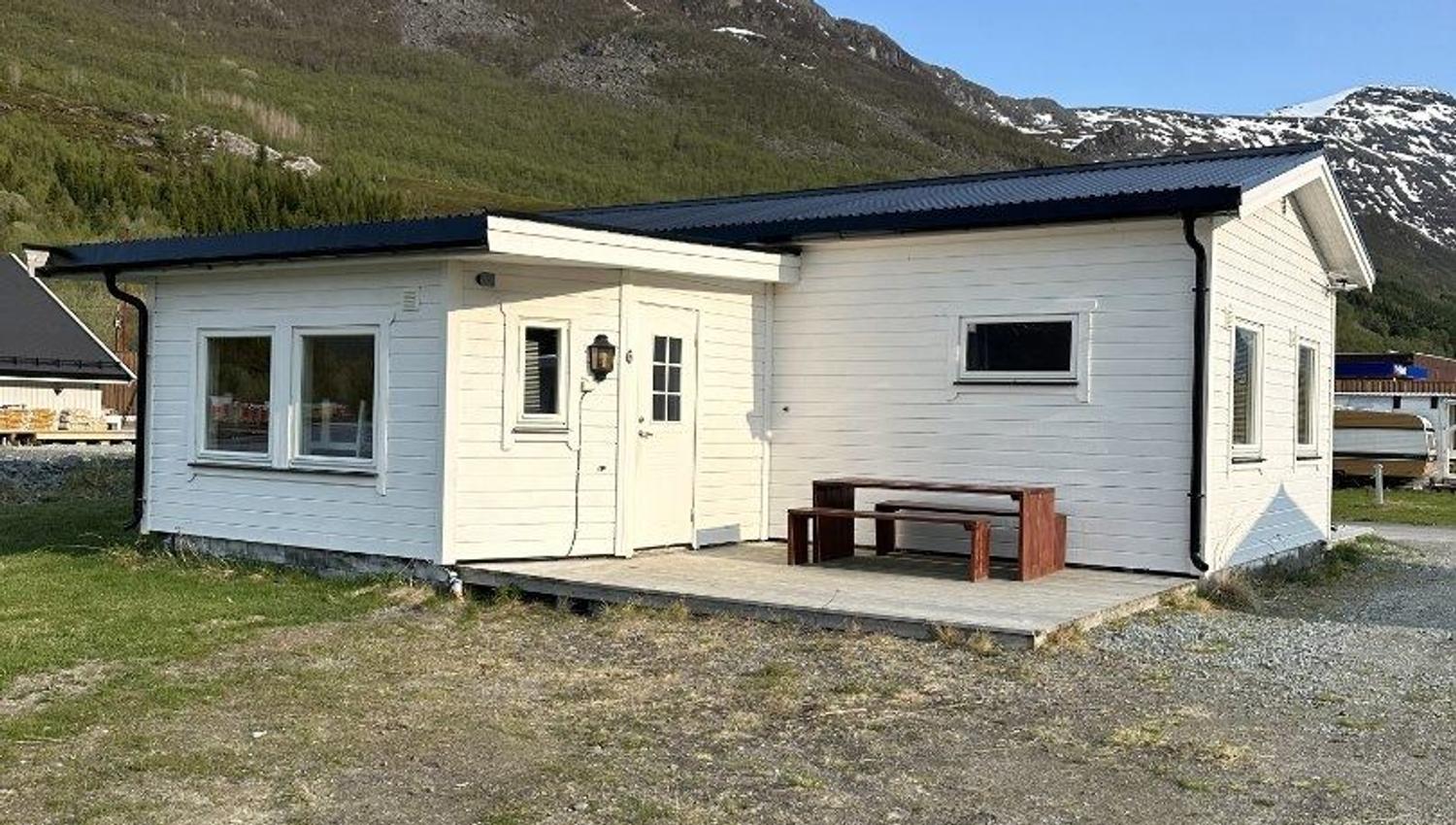 A white cabin with a outside deck