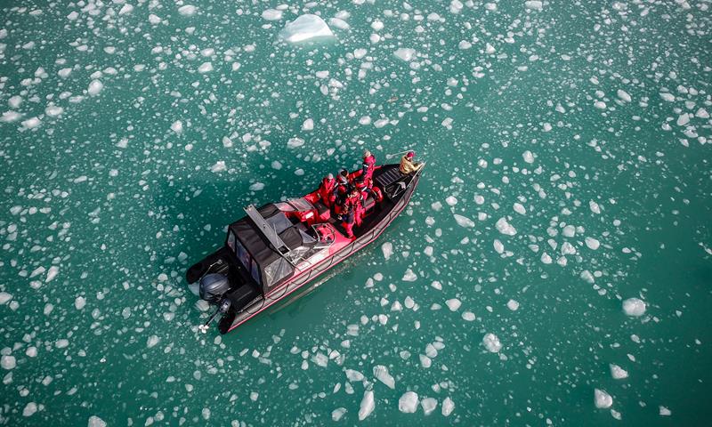 Guests on board a boat sailing in icy waters