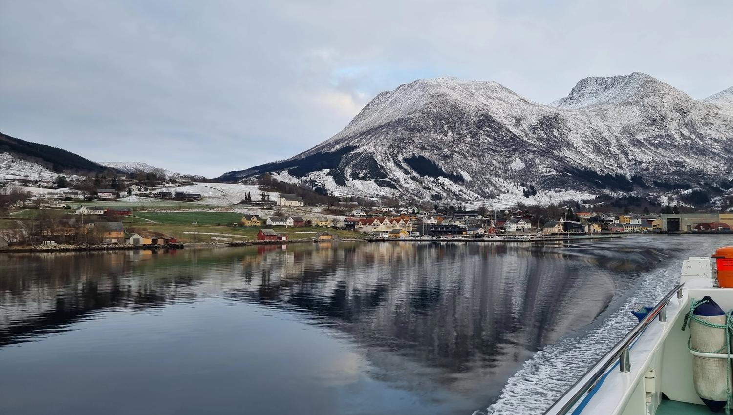 Panoramic view of the fjord and mountains from Hardangerfjordekspressen on a sunny winter day.