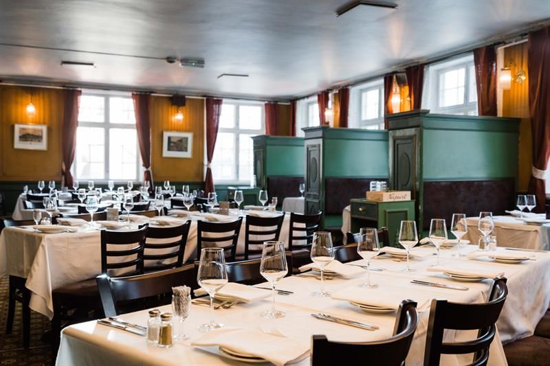 Long tables set for dining with white tableclothes