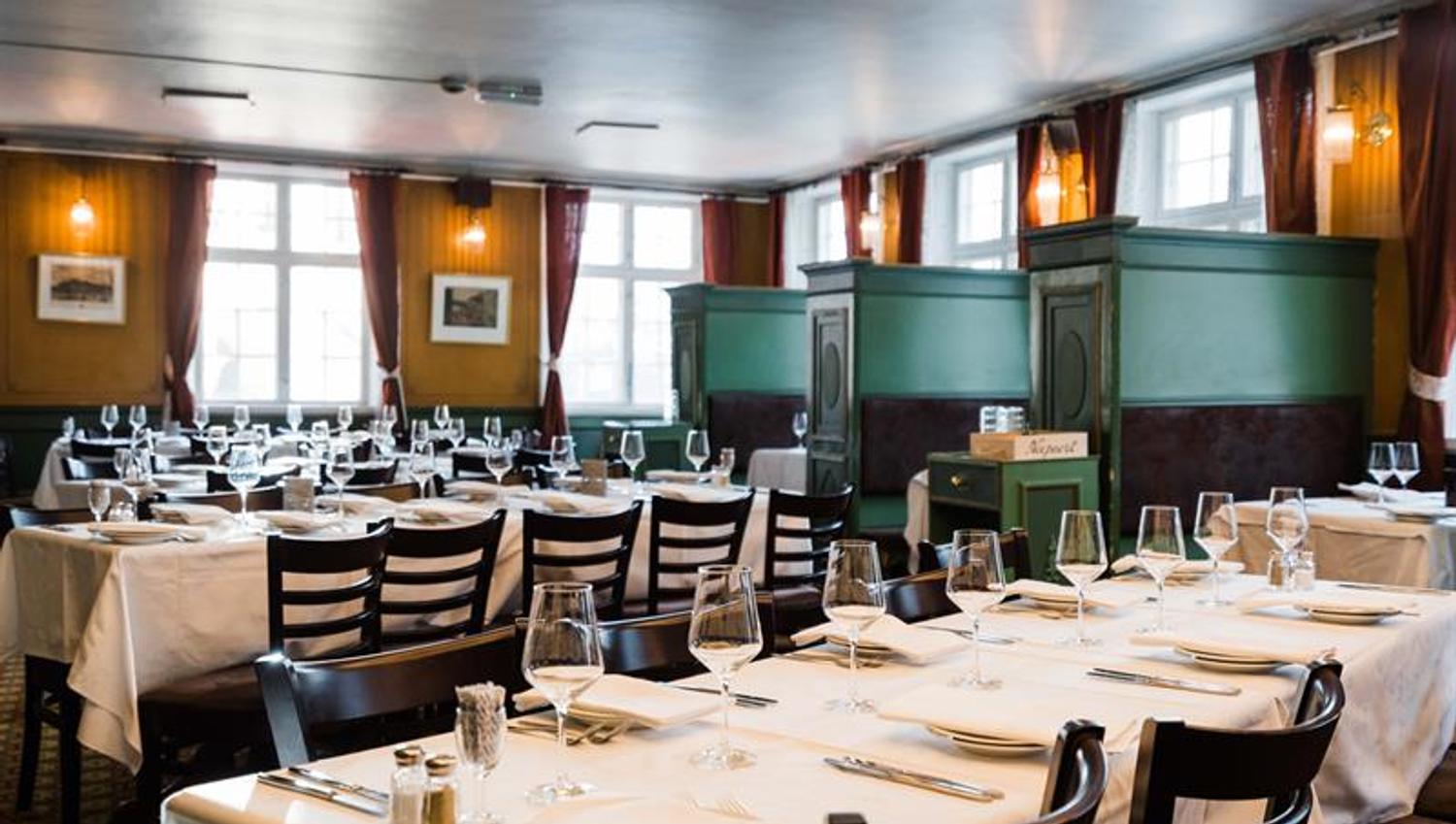 Long tables set for dining with white tableclothes