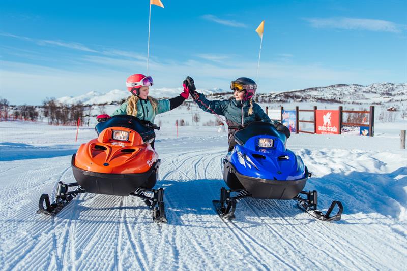 girls riding snowmobiles