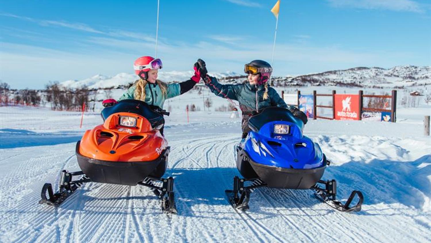 girls riding snowmobiles