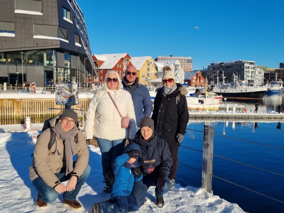 A group of guests posing for a photo in Tromsø city centre