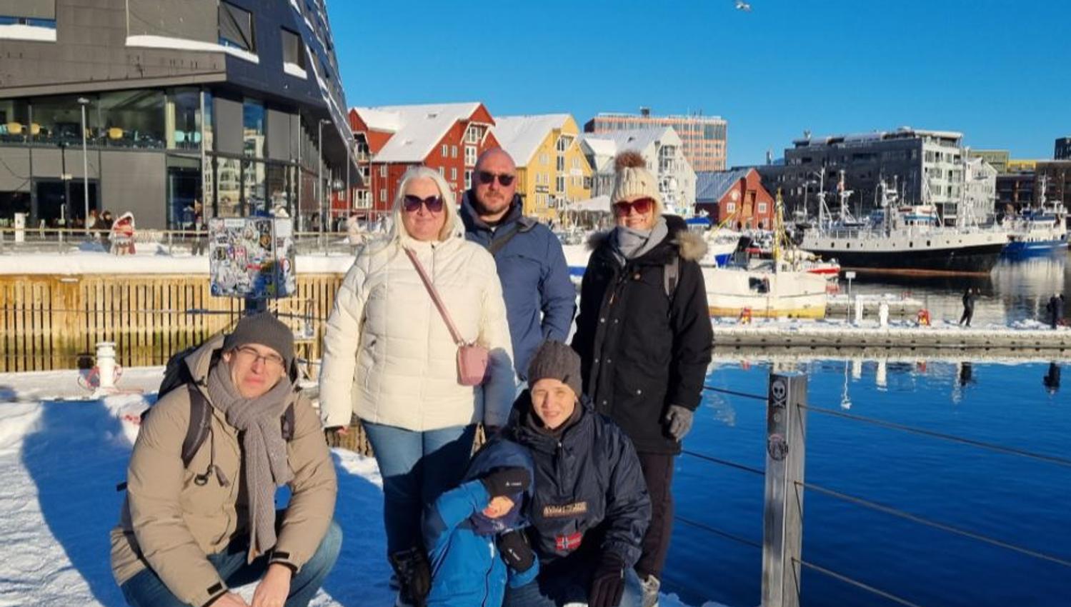 A group of guests posing for a photo in Tromsø city centre