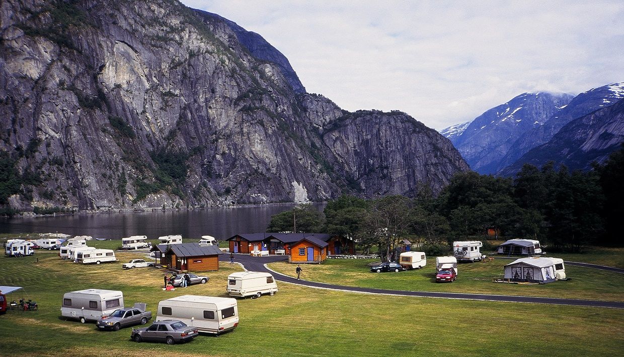 View of the campground with cabins, cars and caravans.