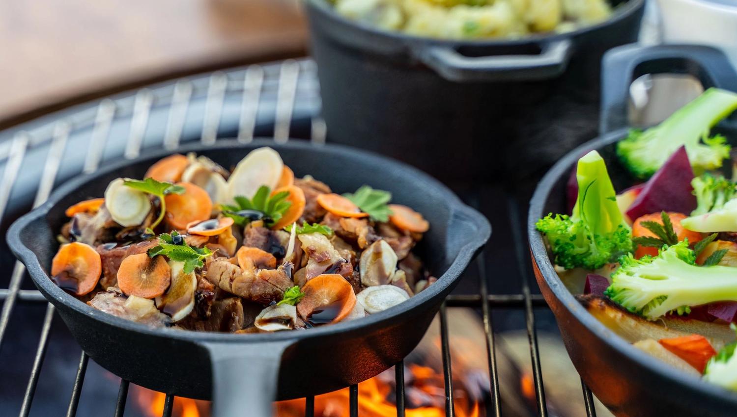 Close-up of flavorful grilled dishes with root vegetables and herbs.