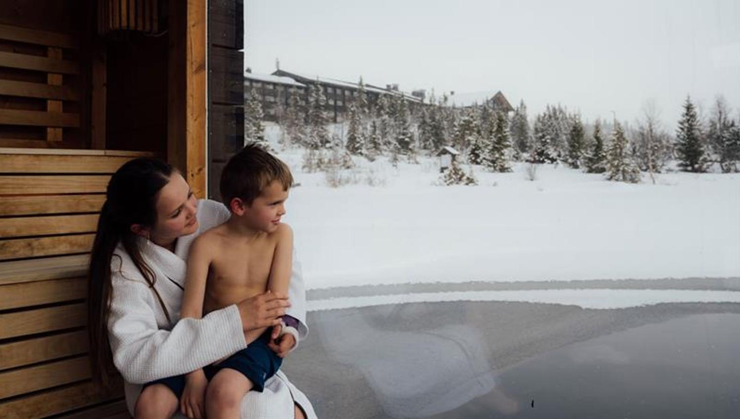 girl with boy on a floating sauna at Gausta in winter