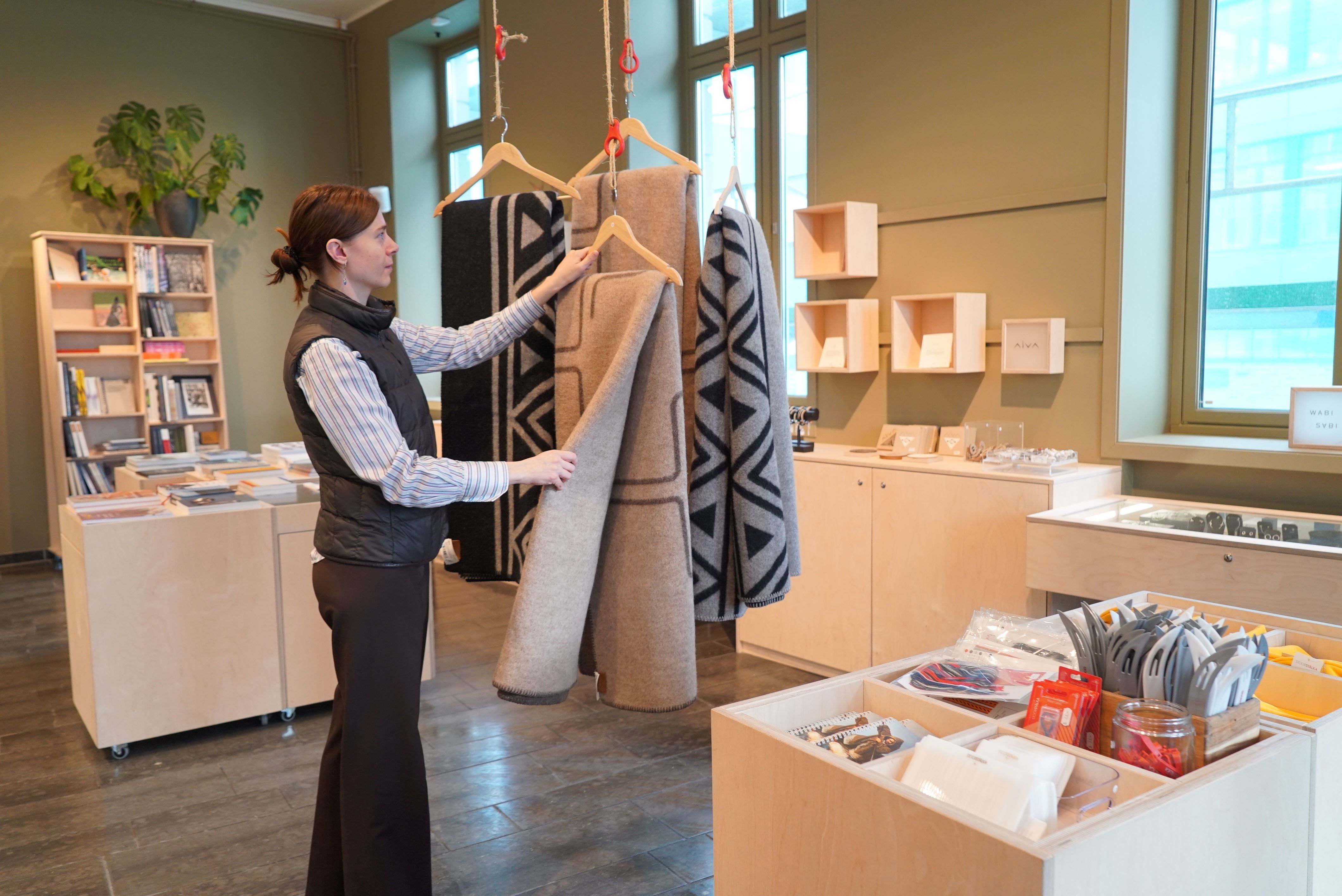 A guest looking at a plaid in the giftshop