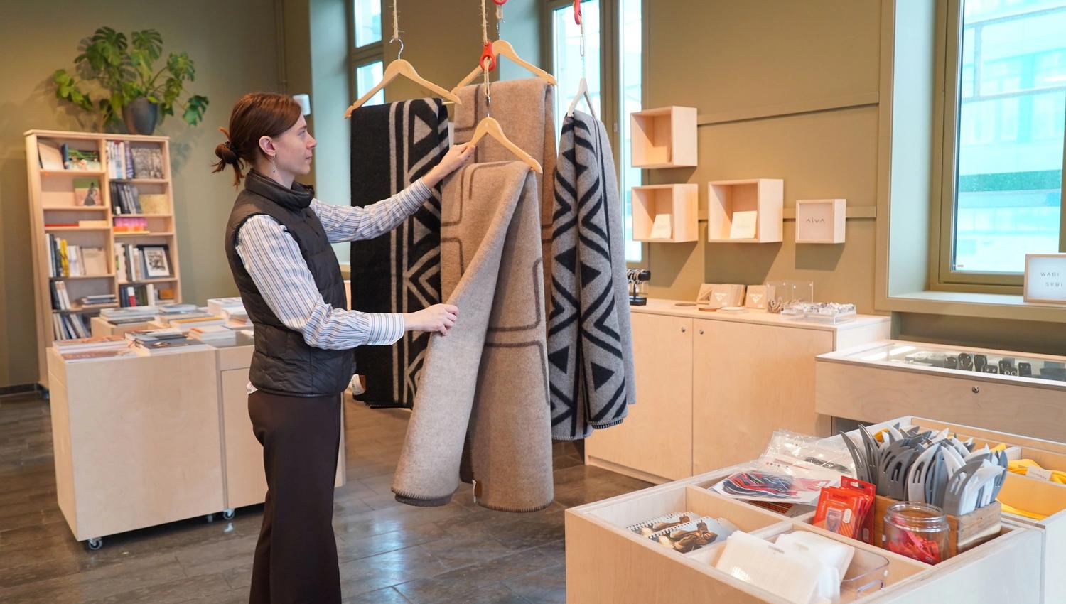 A guest looking at a plaid in the giftshop
