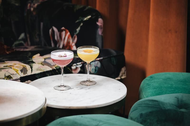 Detail photo of two drinks on a table.
