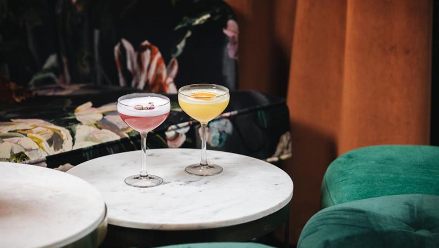 Detail photo of two drinks on a table.