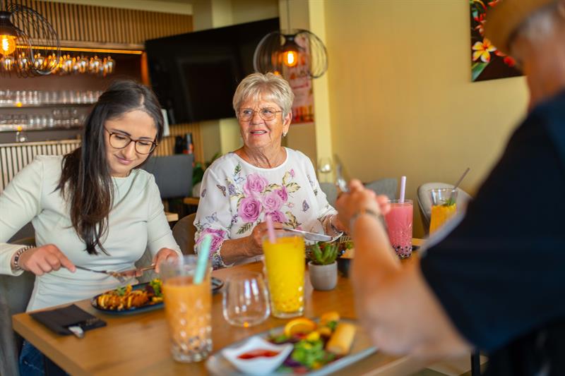 Hyggelig stemning rundt bordet mens gjestene nyter et måltid på Taste of Thai.