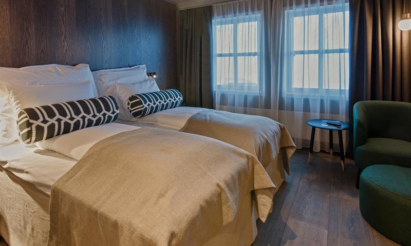 Two hotel beds in a hotel room