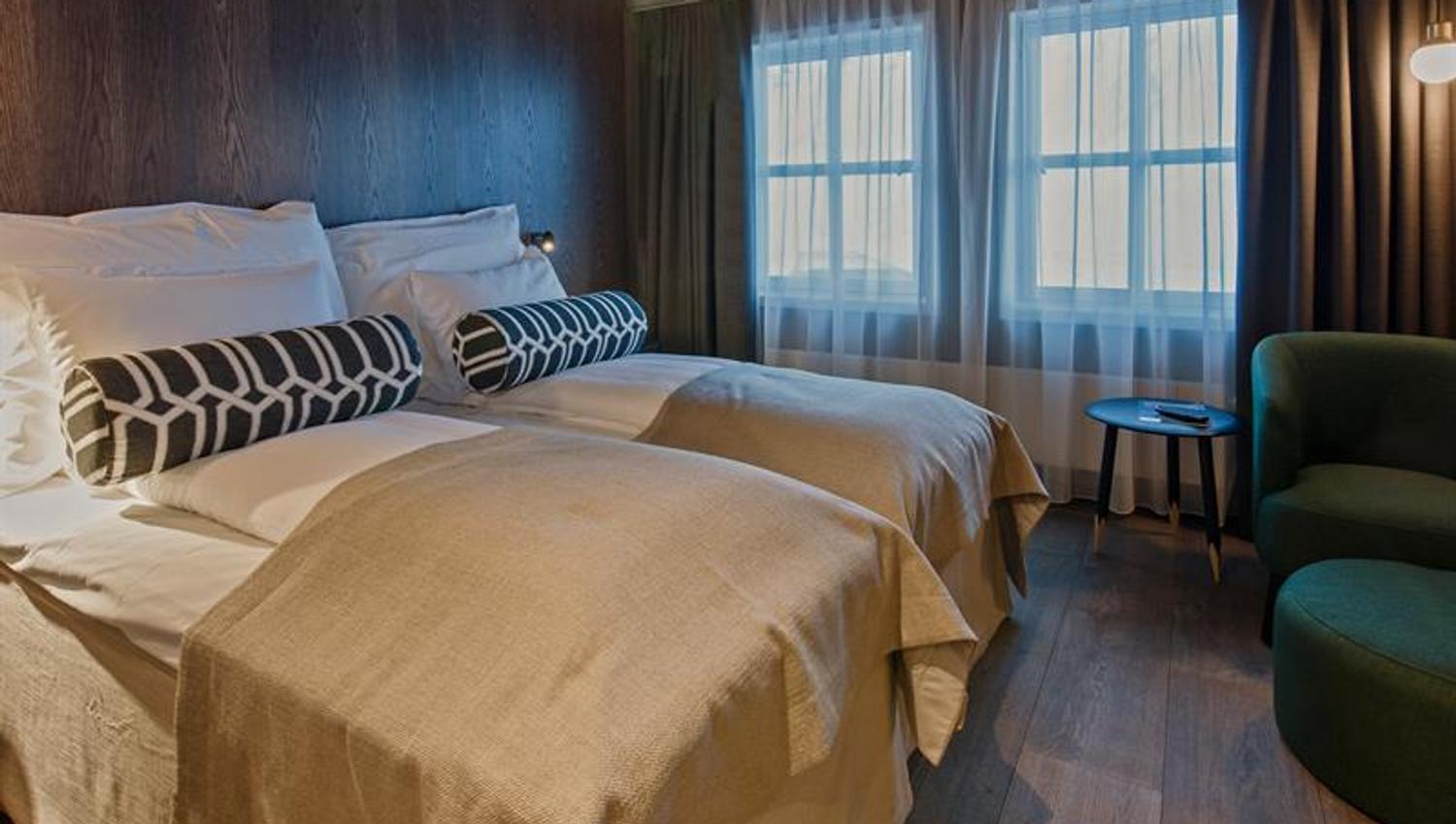 Two hotel beds in a hotel room