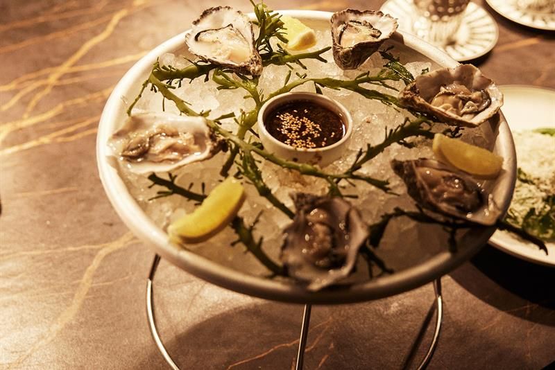 Detail of oysters on a plate.