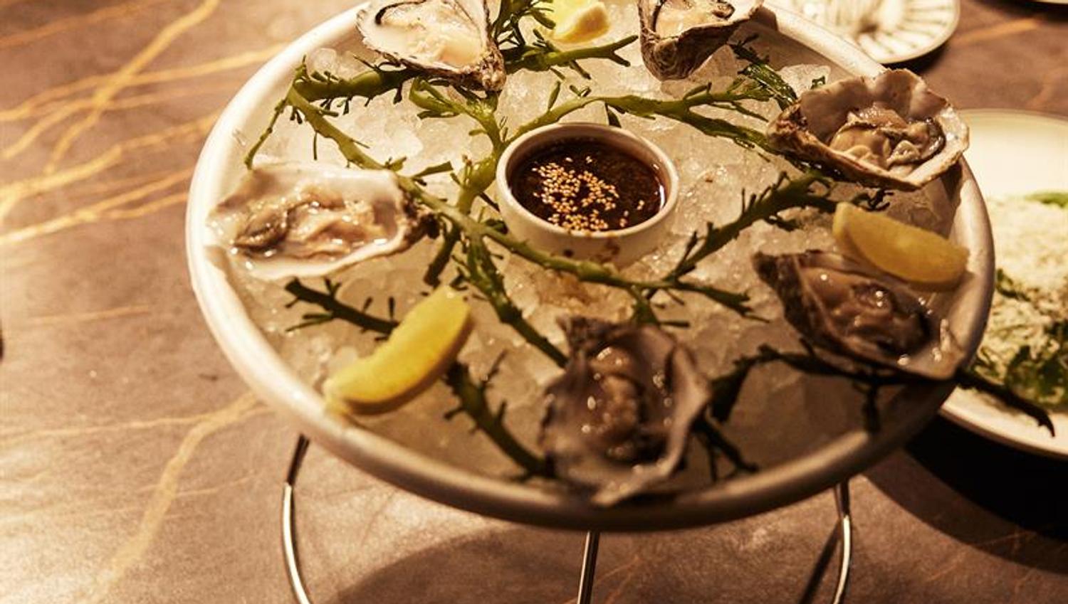 Detail of oysters on a plate.