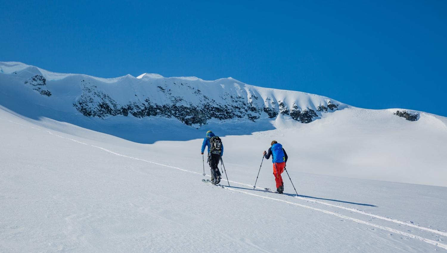 På vei til topps i snøkledde fjell.