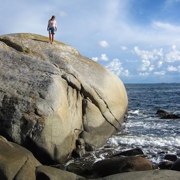 Person on mountain by the sea