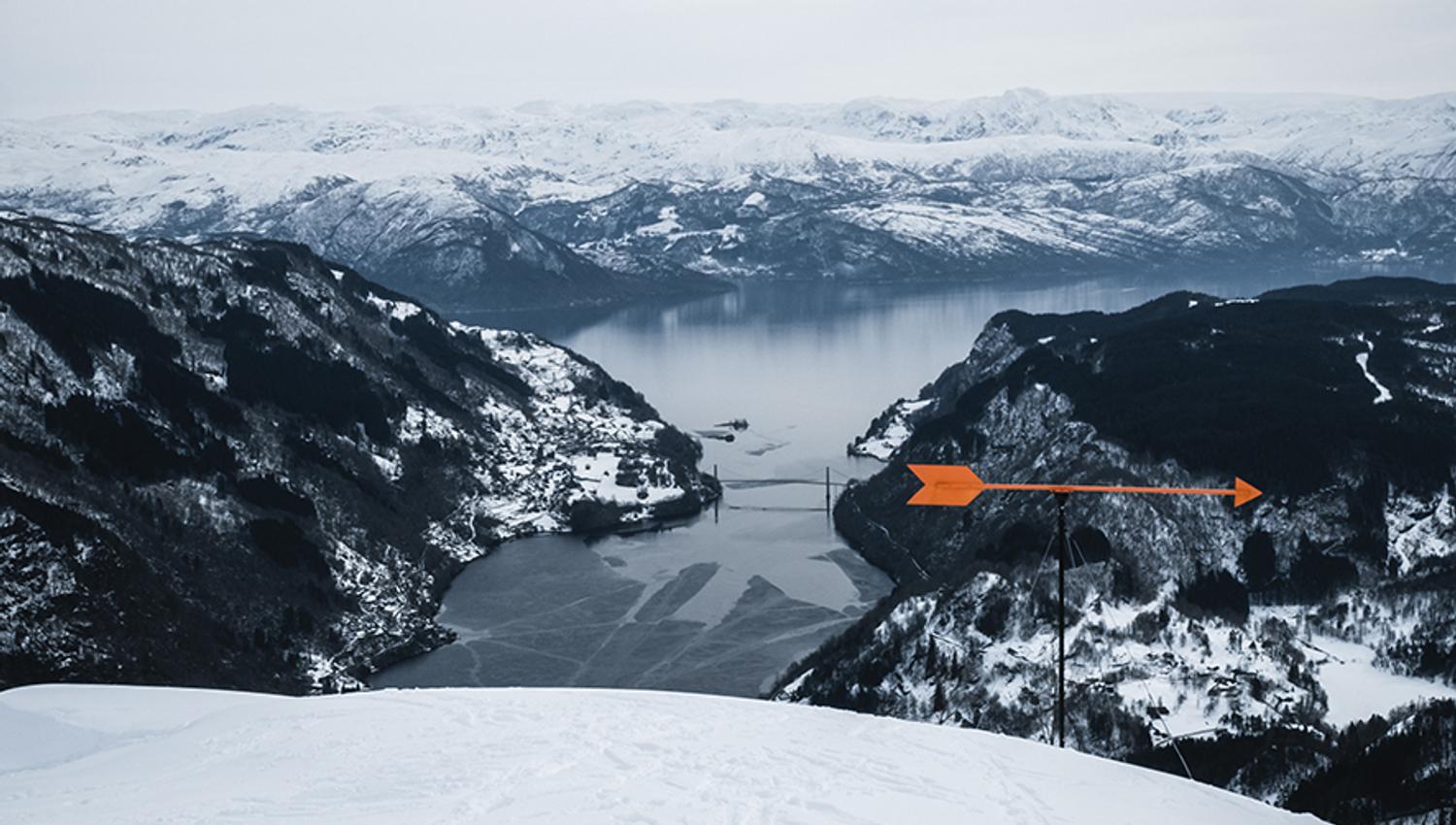 View of the Hardangerfjord from snowy mountain slopes.
