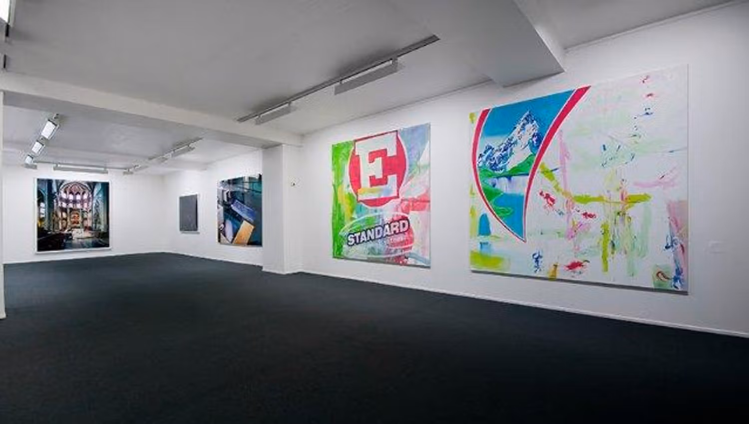 Various large pop art paintings hanging on white walls.