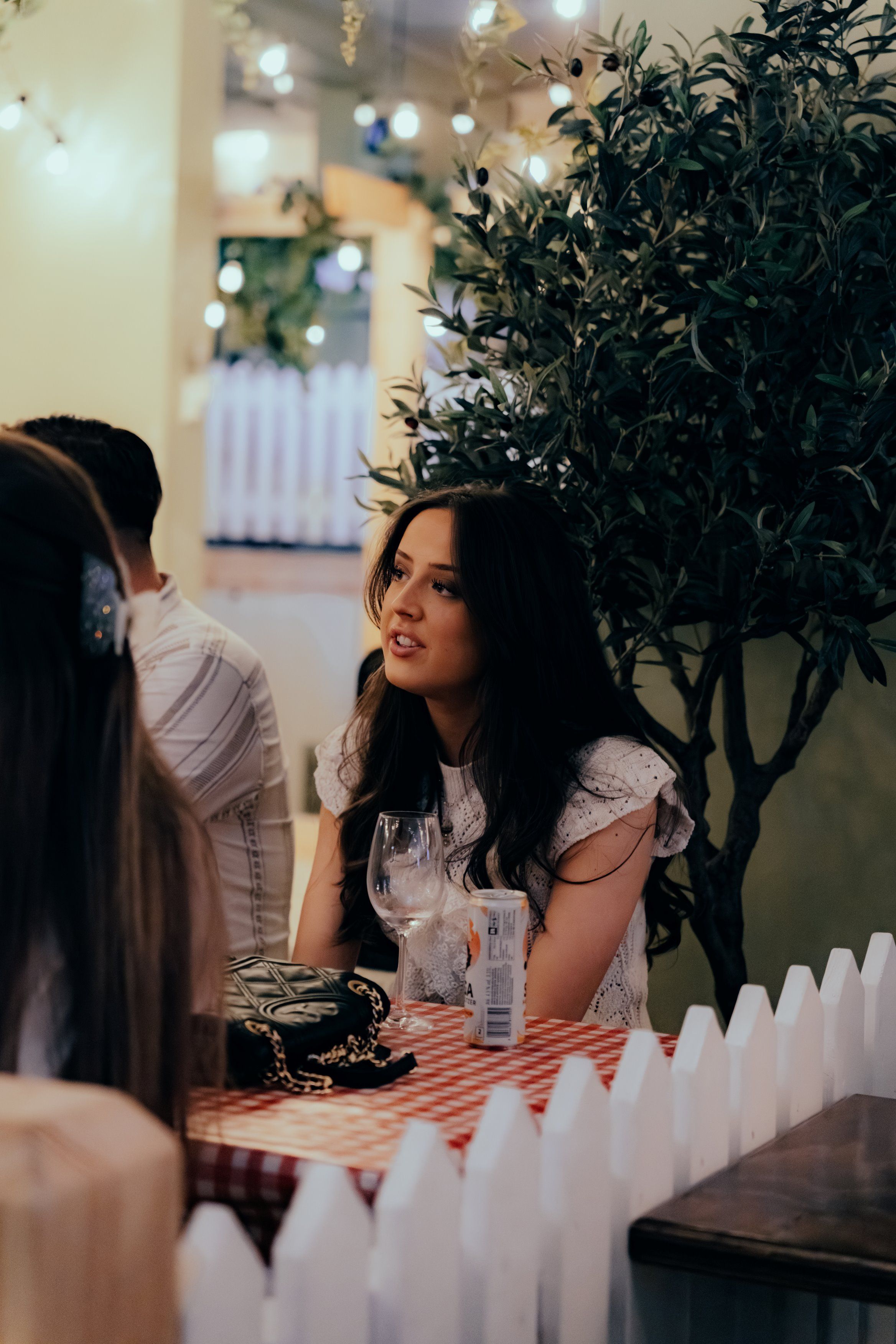Two girls drinking by a table