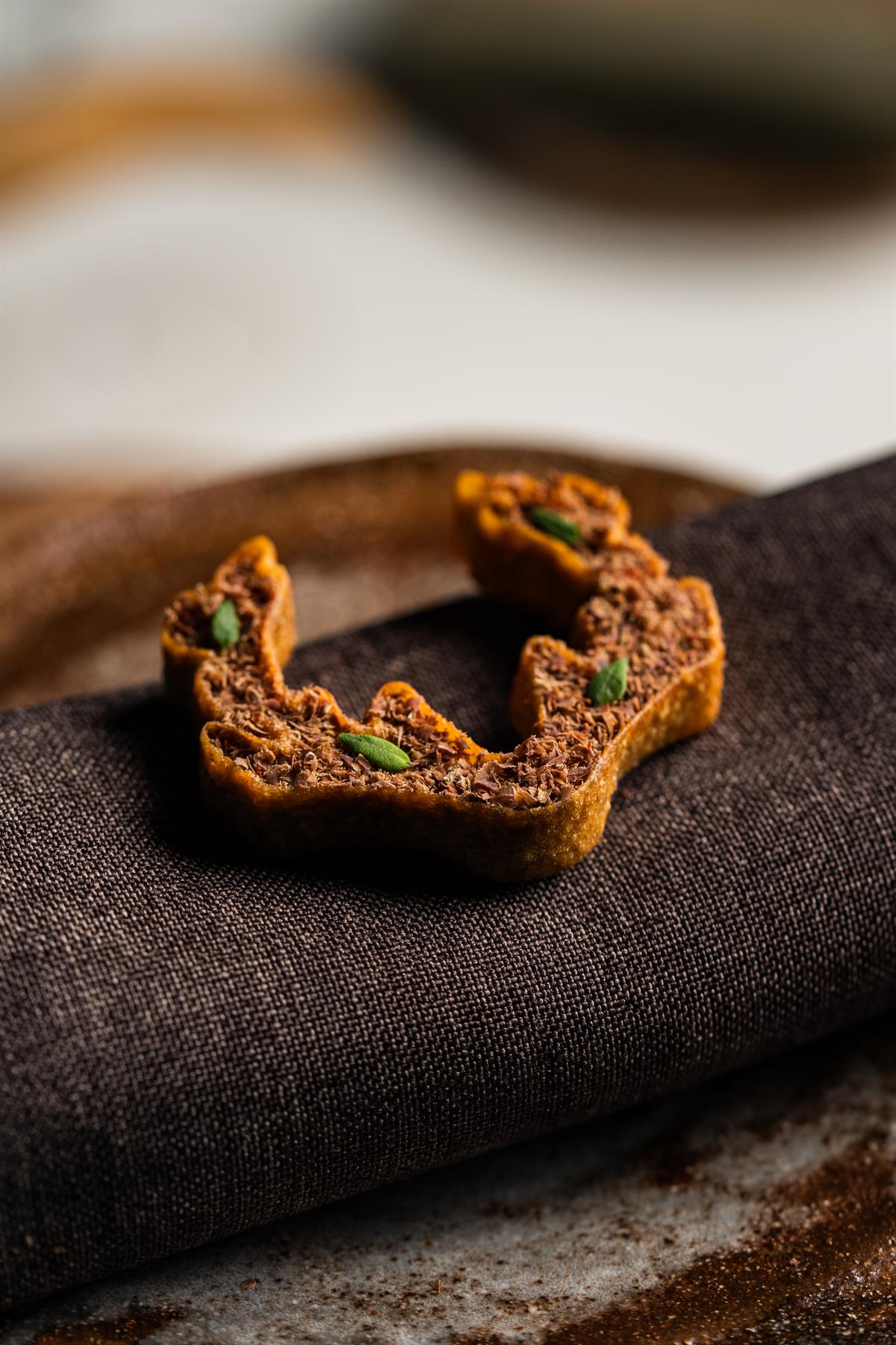 Crispy snack served on a dark cloth.