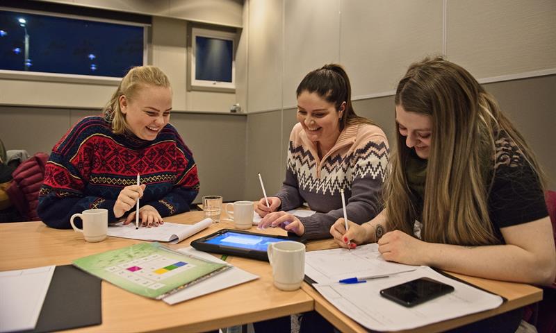 Three persons working together in a conference room