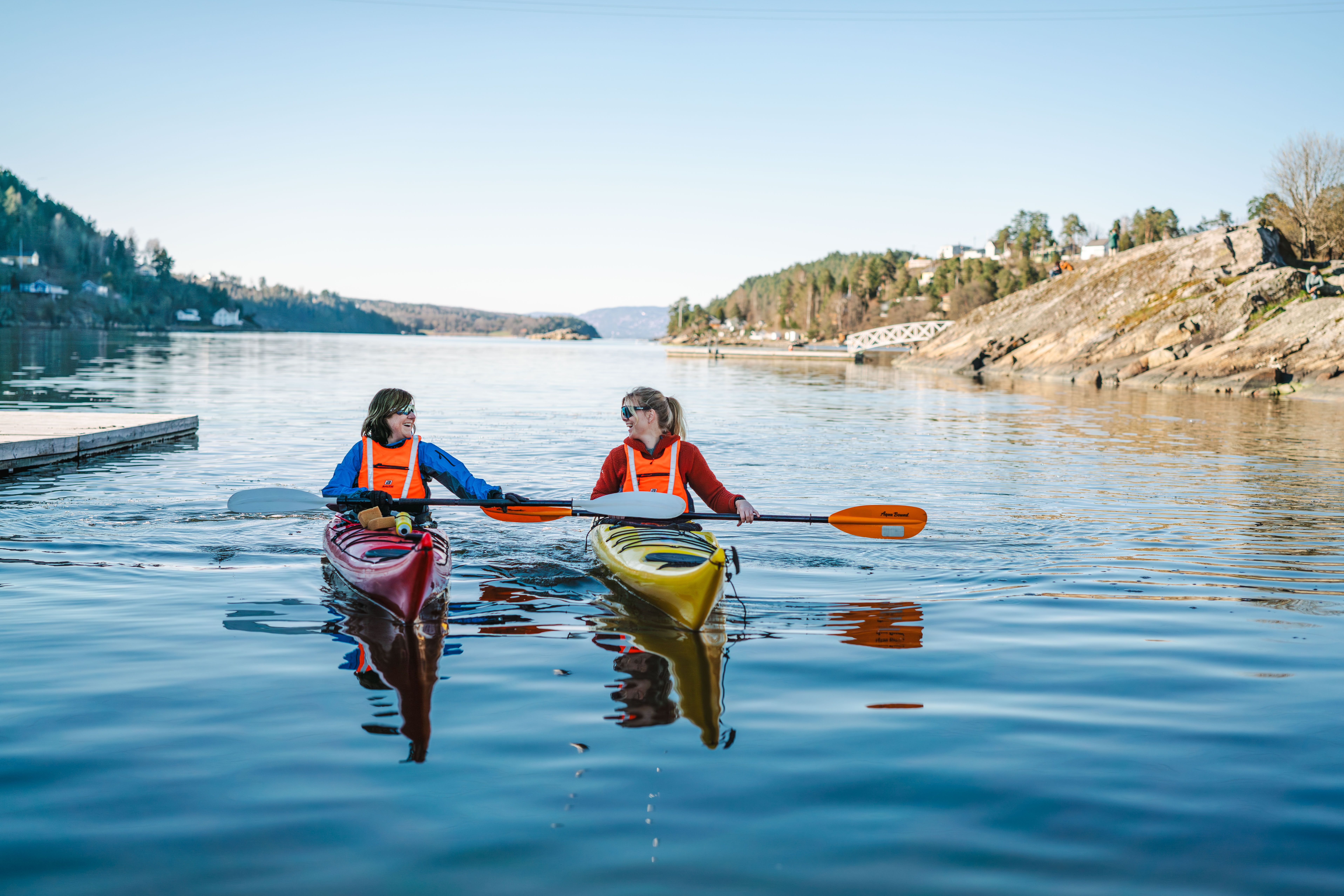2 people in kayak, blue water 
