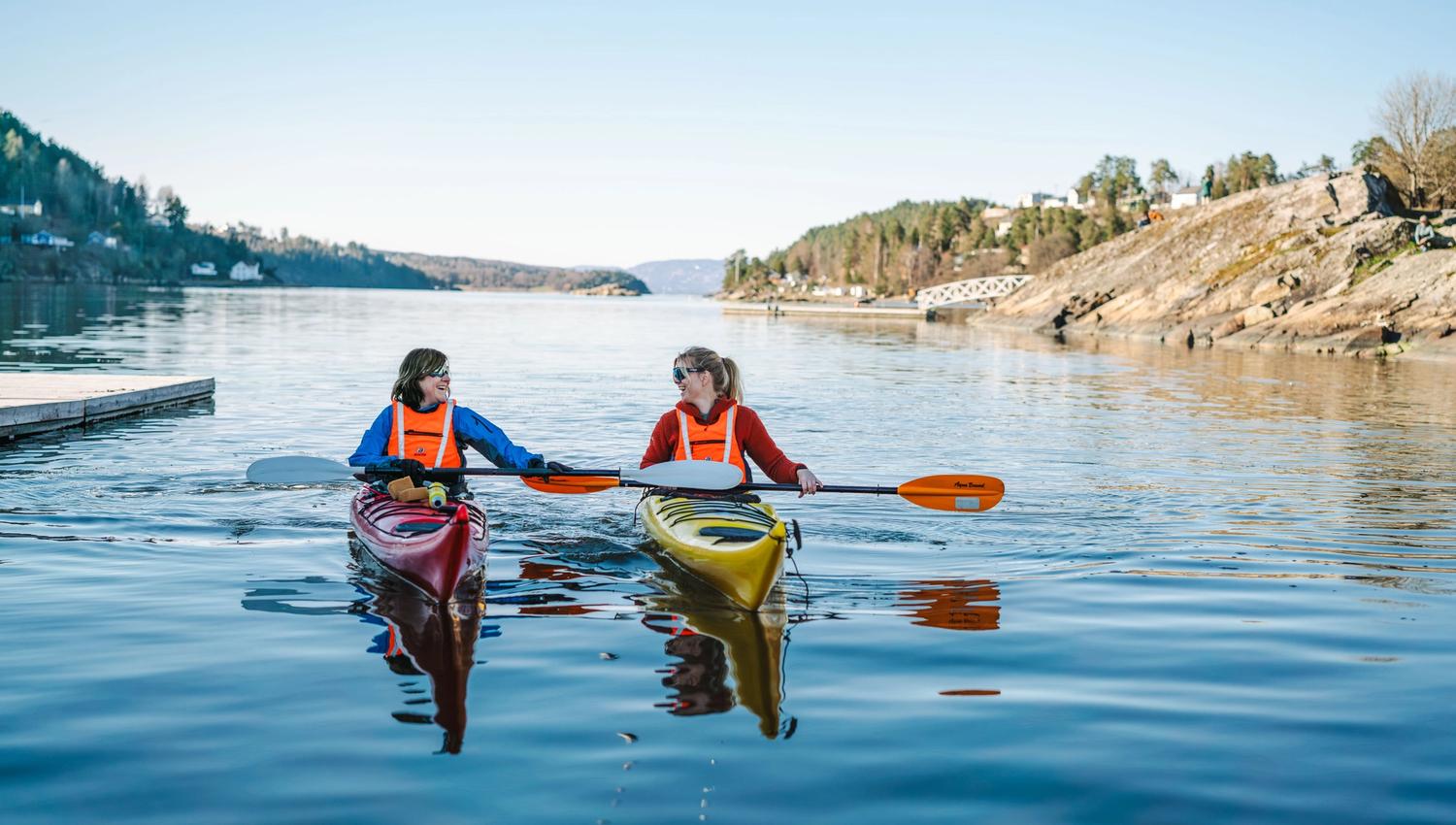 2 people in kayak, blue water
