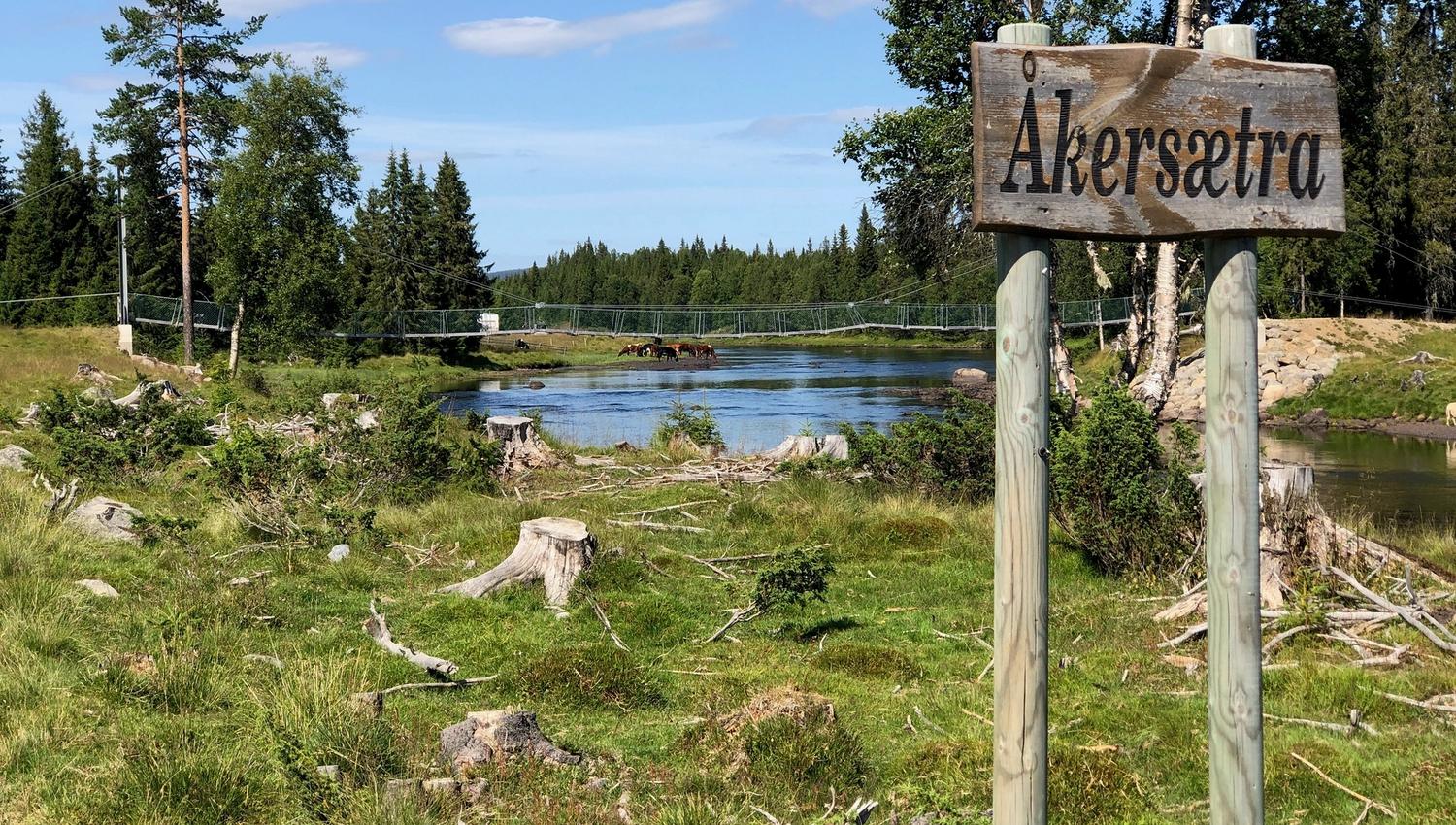 Skilt med Åkersætra, hengebrua over Astelva i bakgrunnen