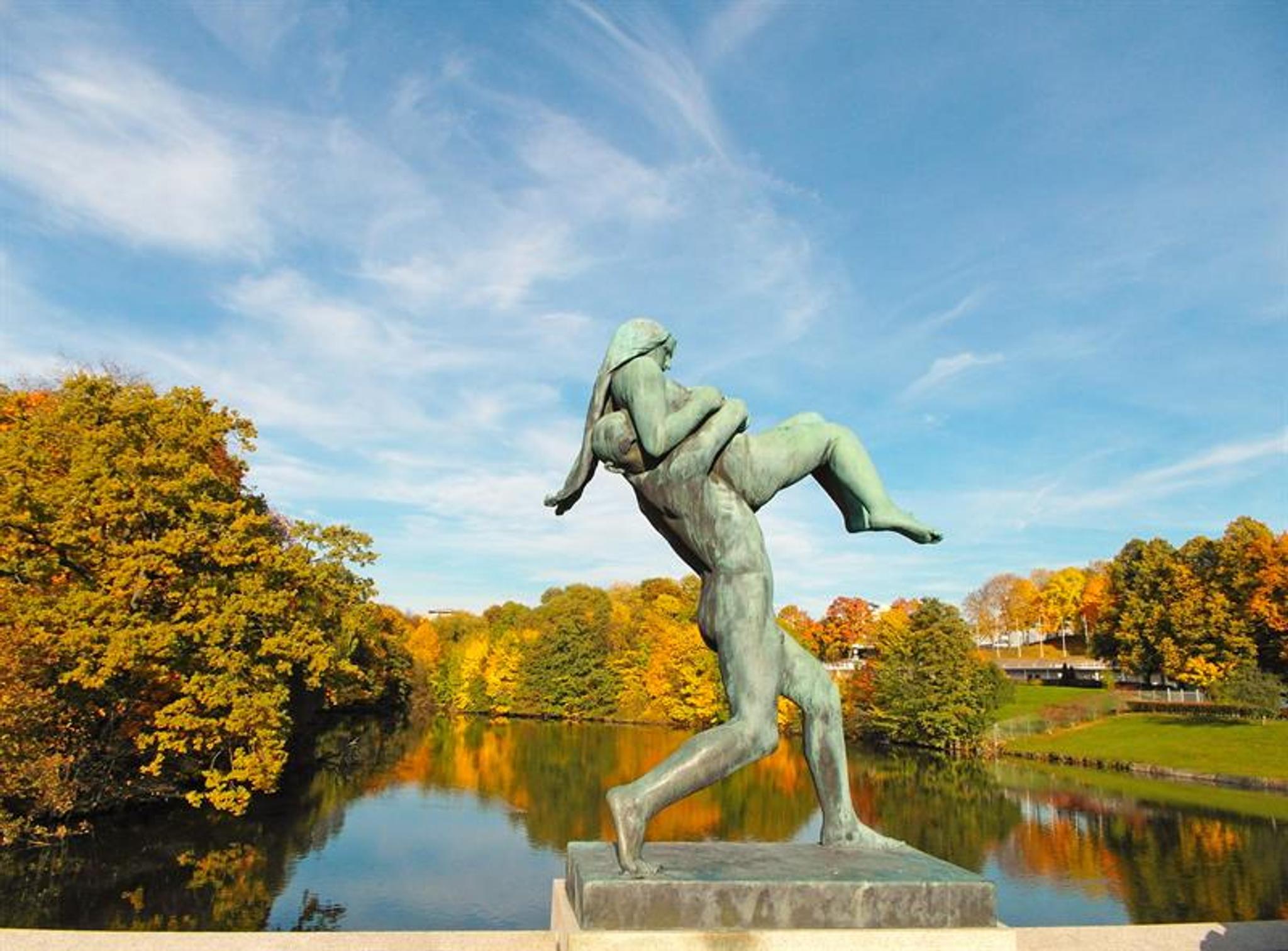 Statue on the bridge of a man carrying a woman.