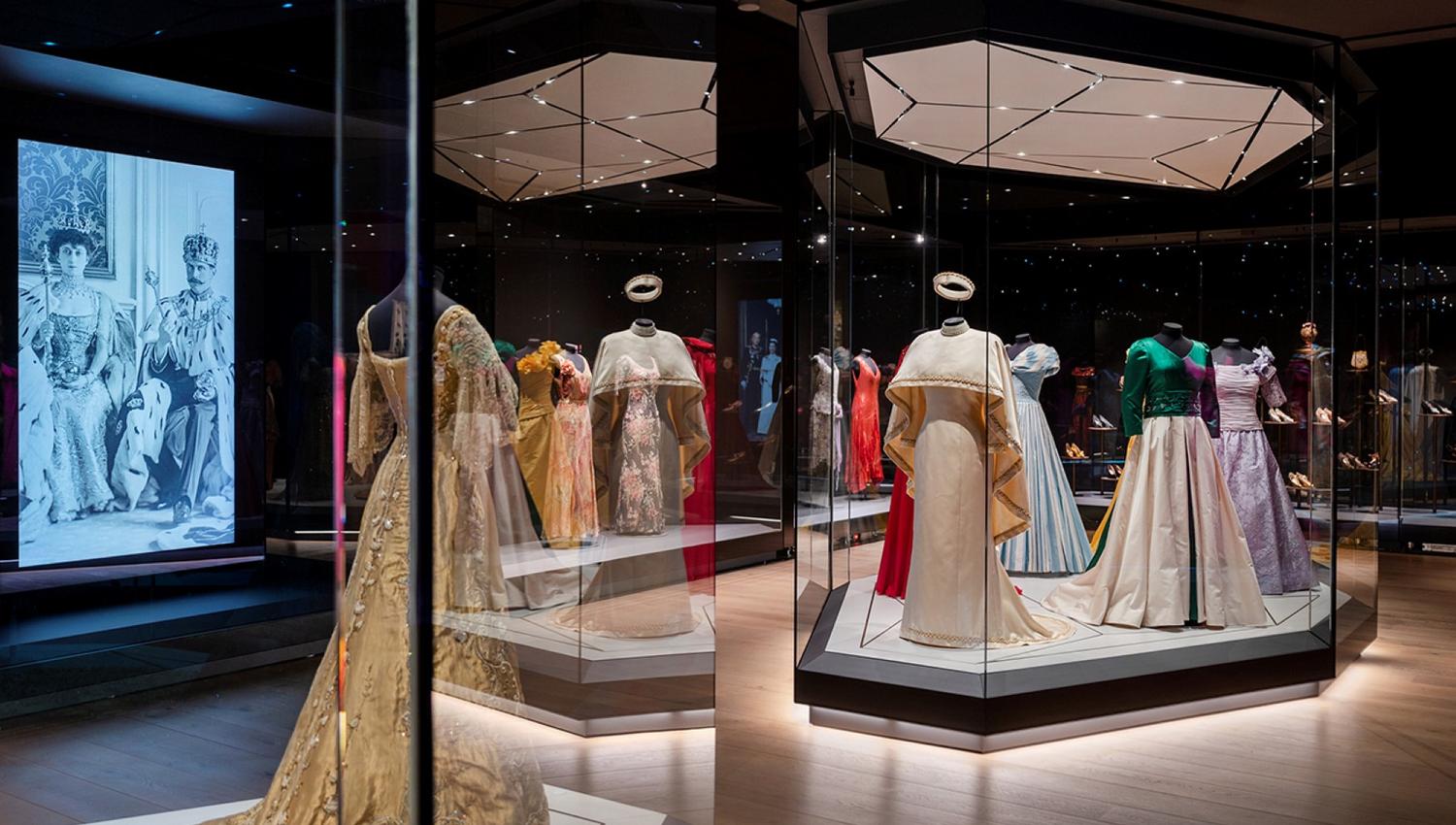Various dresses on display in an exhibition.