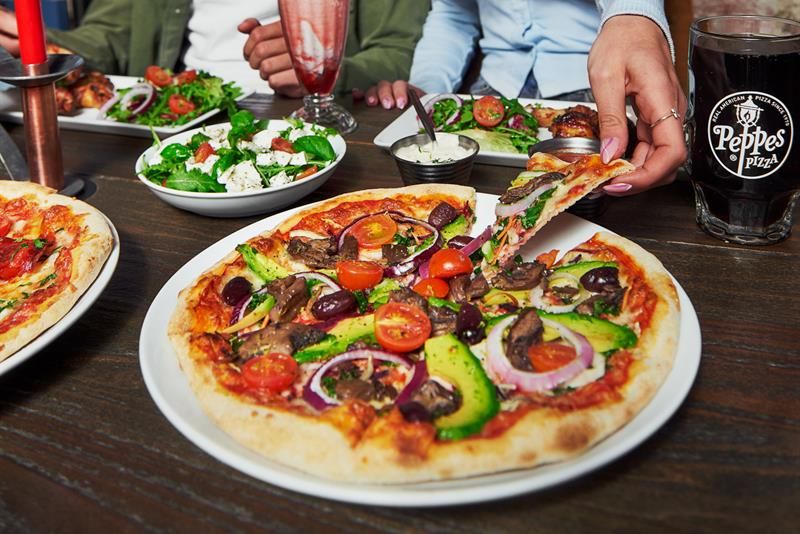 Two people eating pizza.