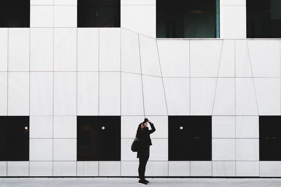 White building with person taking a picture.