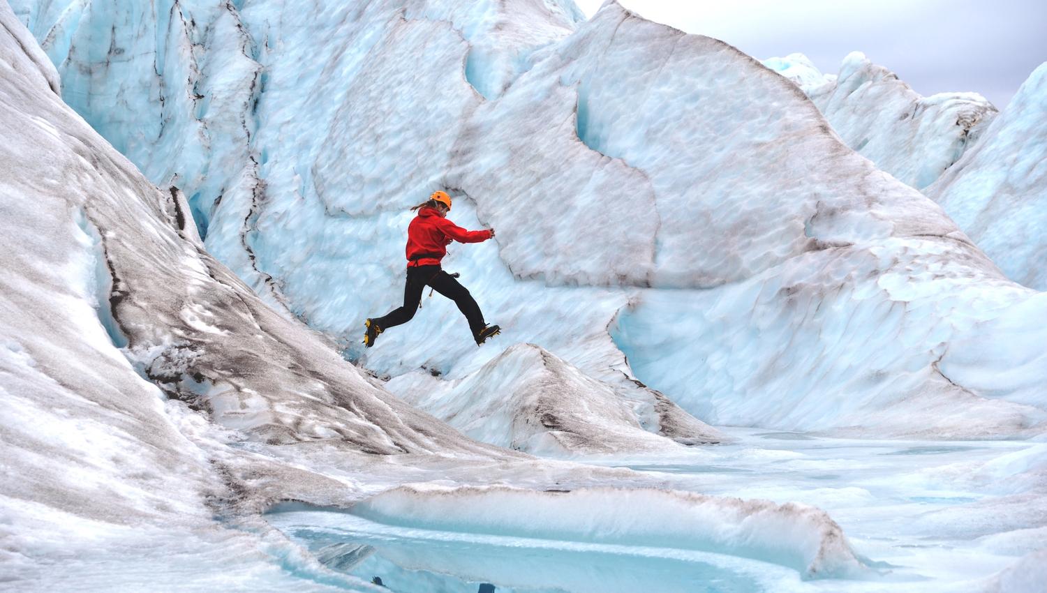Person jumping on a glacier