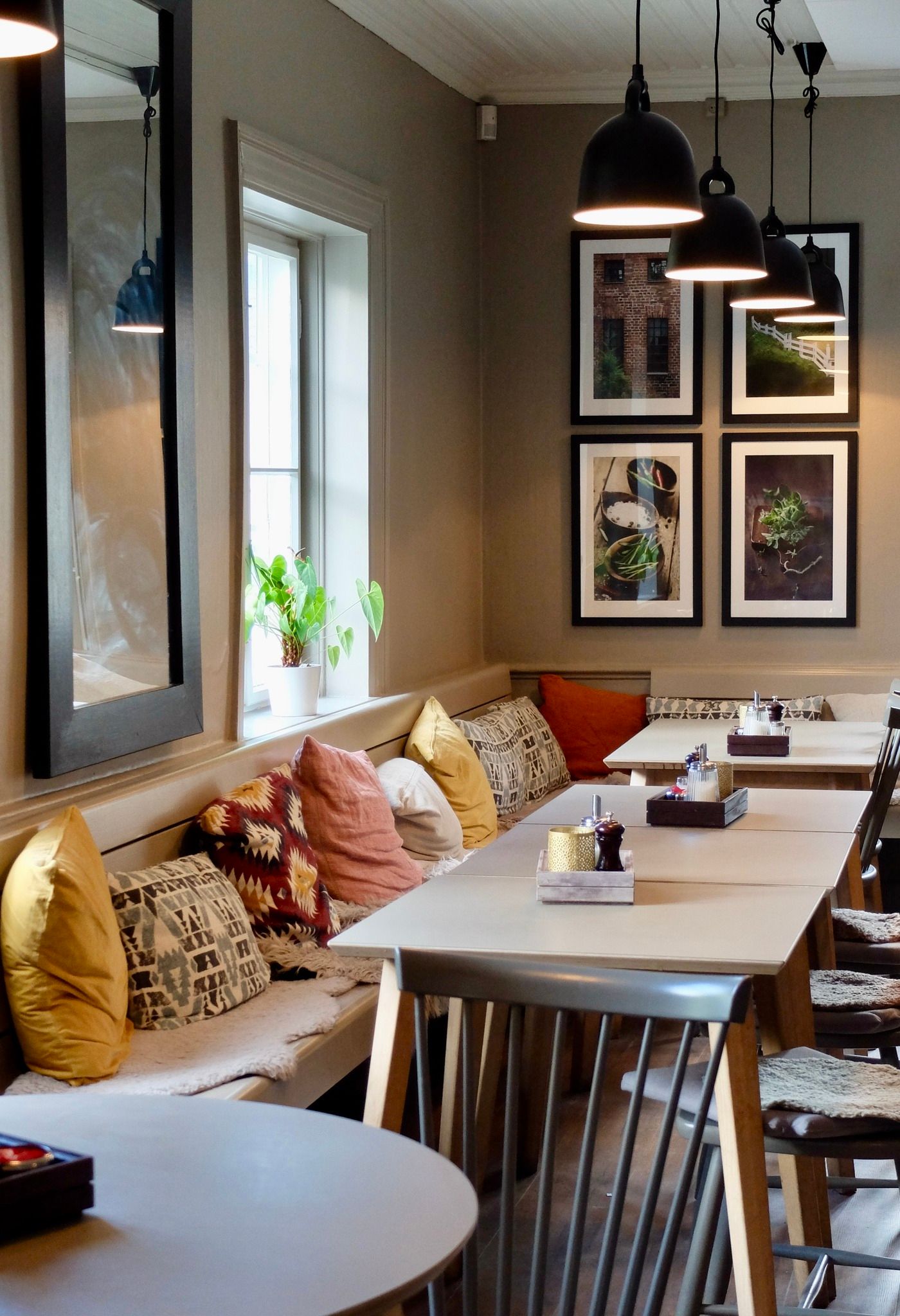Table and bench with pillows in restaurant