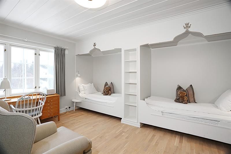 Guest room, two separate beds, desk, armchair. Photo.