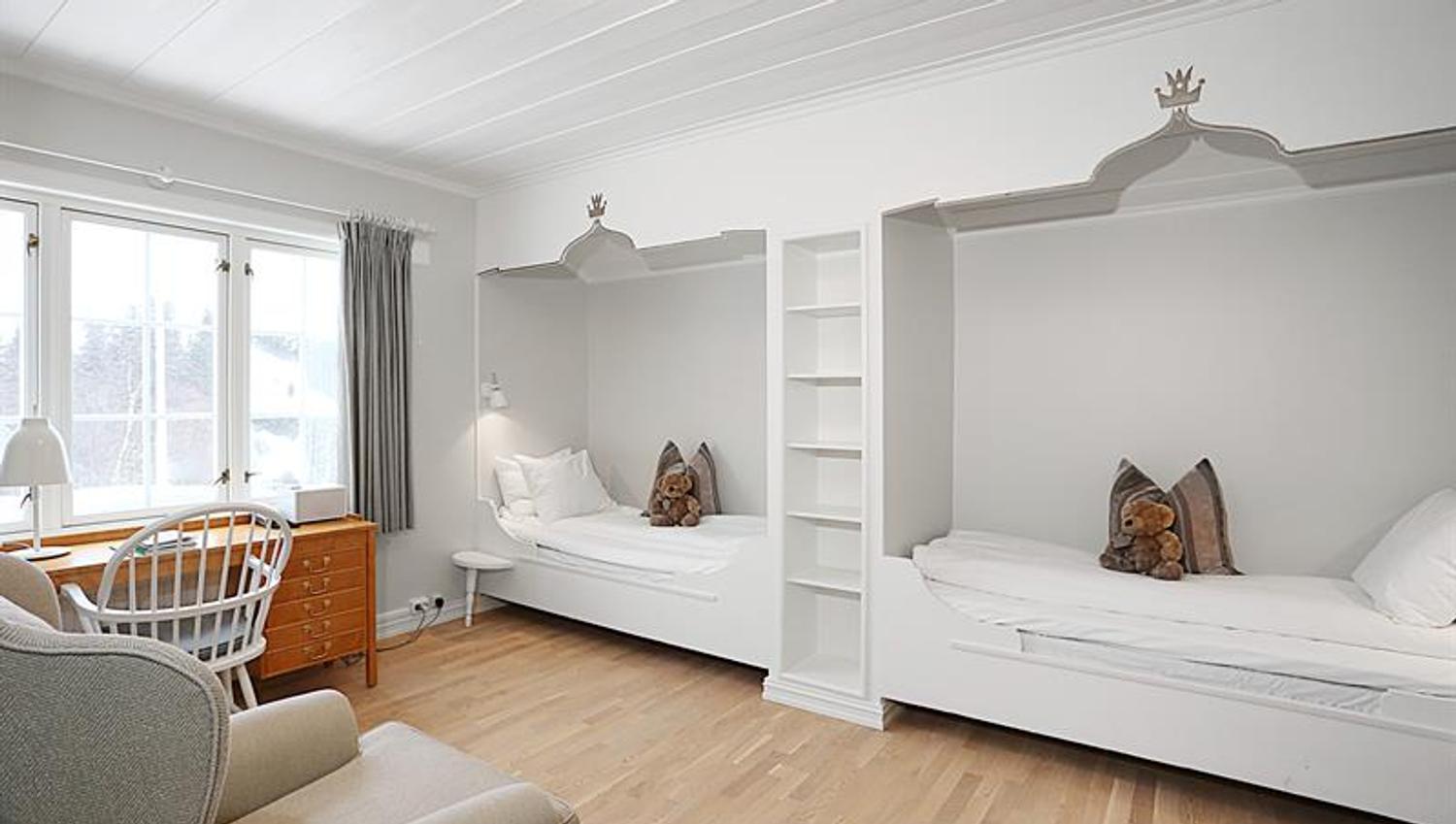 Guest room, two separate beds, desk, armchair. Photo.